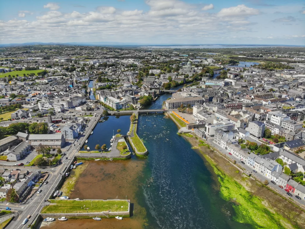 Aerial image of Galway City on a sunny day with the river in the centre.
